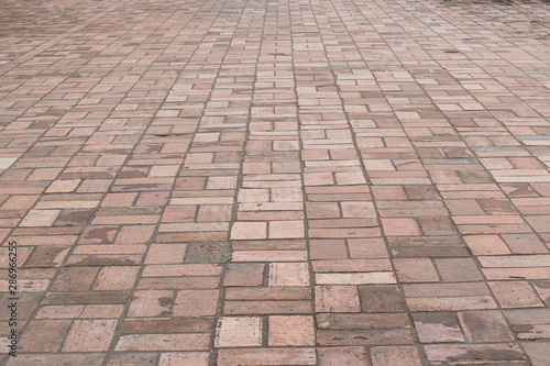 Perspective view brick stone pavement on the ground for Street Road. Vintage ground flooring square pattern texture for mock up.
