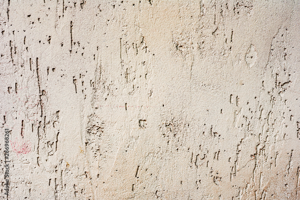 Fototapeta premium Texture of a concrete wall with cracks and scratches which can be used as a background