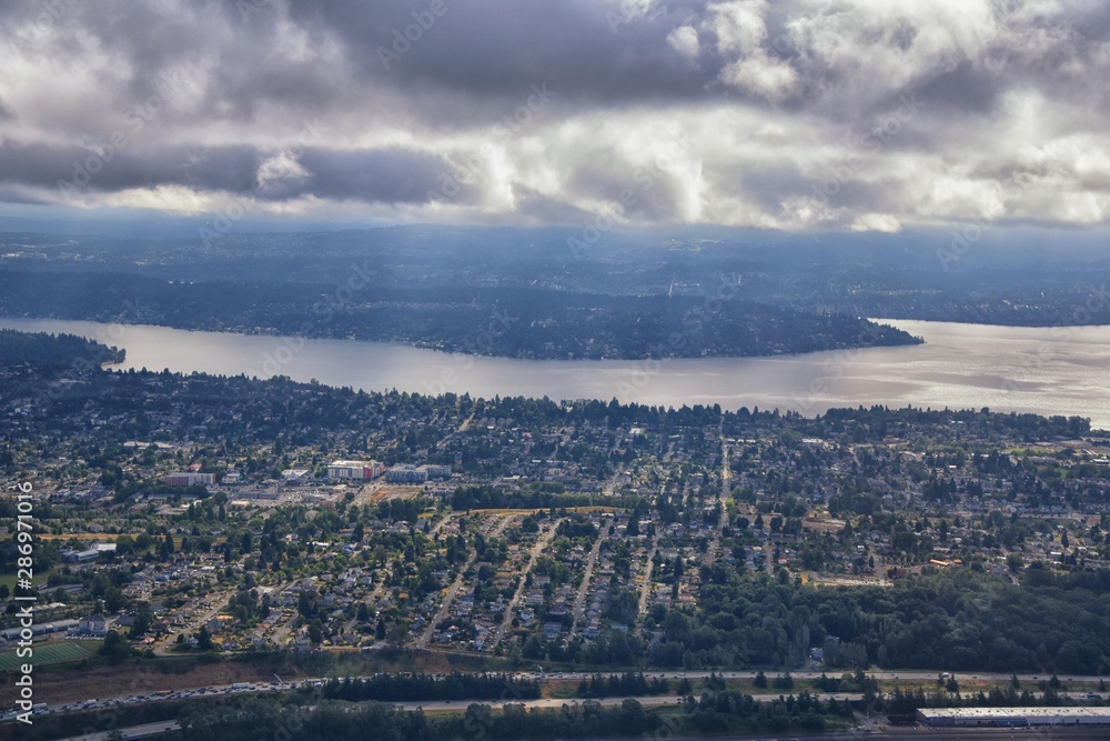 Seattle, Washington, 2019 Cityscape Aerial Panoramic View through cloudscape including Ocean, rivers and rural urban. USA.