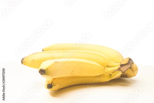 Yellow fresh banana isolated against white, selective focusing