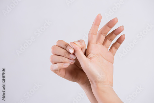Healthcare and medical concept. Woman massaging her painful thumb finger.