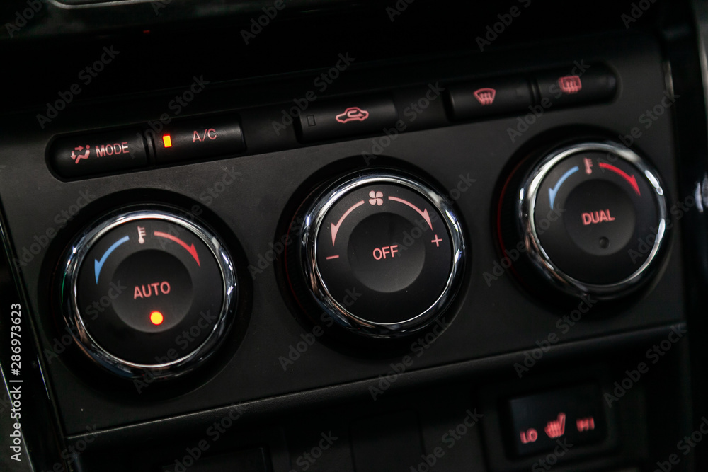 Modern black car interior: climat control view with air conditioning button, the dashboard with information about temperature inside a car. Modern black car interior: climat control view with air conditioning button, the dashboard with information about temperature inside a car.
