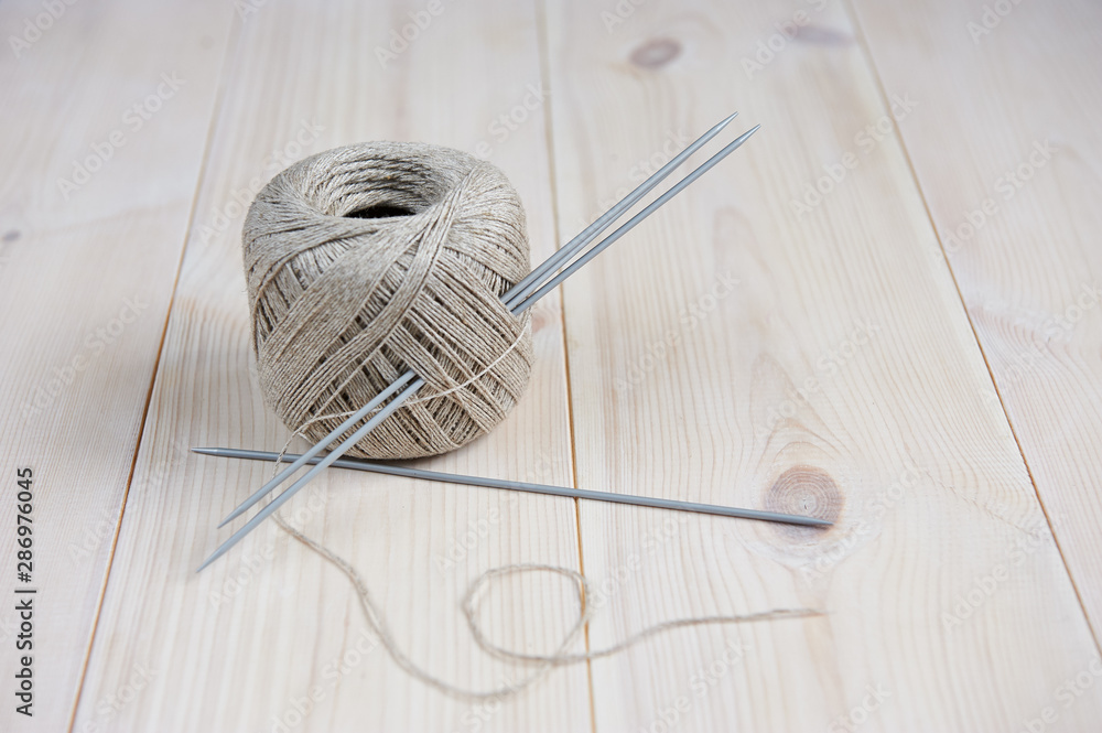 knitting needles inserted into a ball of yarn, hobby concept