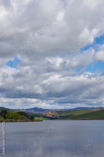 Backwater Reservoir set in the Angus Glens near to the town of Kirriemuir on a fine May morning. Angus Glens, Scotland.