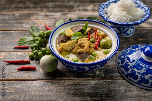 Thai food chicken green curry on dark wooden background. top view , Free space for text input
