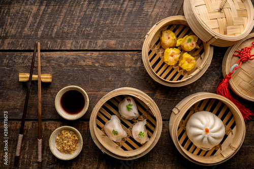 Dim sum  Dim Sum on the wooden table  top view and space for text input   Dim Sum  Chinese food  in steamed bamboo