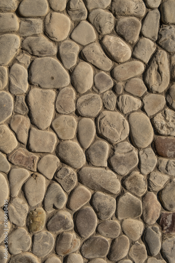 Abstract nature pebbles..Natural pebble stone background. .Background of natural pebbles bonded with cement mortar.