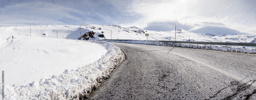 Road in ski resort of Sierra Nevada in winter, full of snow.