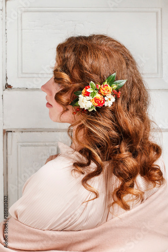 Young woman with fresh flowers in her hair.