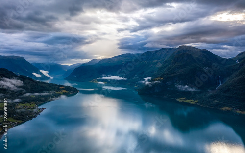 Cloudy morning in Lustrafjord with feigumfossen waterfall, Norway