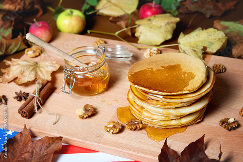 Pancakes with honey on a decorated table. Restaurant dishes.