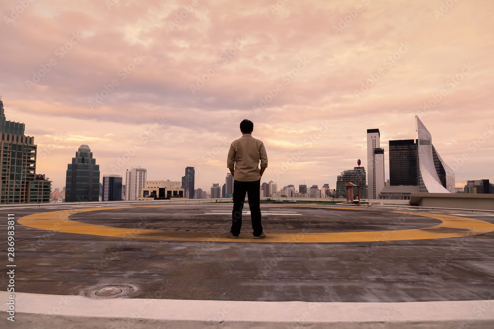 Man is standing on the deck to see the beautiful city .The men are looking at the bright city and look at the city in the future. Man is standing on the deck to see the beautiful city .The men are looking at the bright city and look at the city in the future.