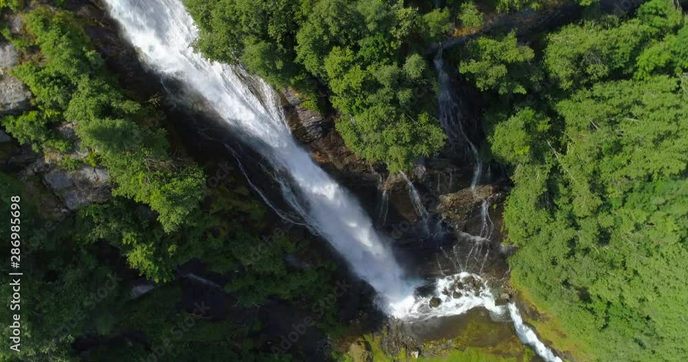 Aerial: Drone moving towards waterfall on rocky cliff - Geiranger Fjord, Norway Aerial: Drone moving towards waterfall on rocky cliff - Geiranger Fjord, Norway