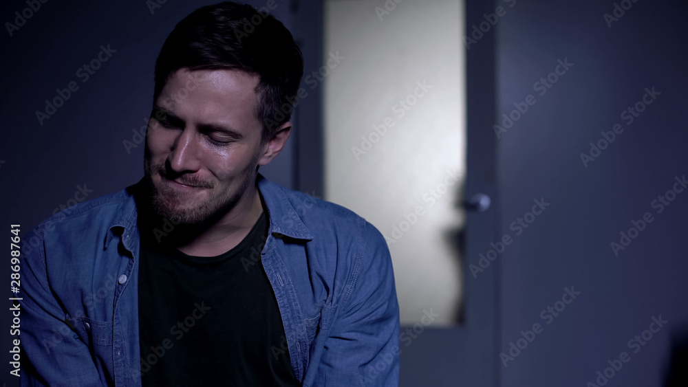 Desperate man crying, experiencing life troubles, small girl standing at door Desperate man crying, experiencing life troubles, small girl standing at door