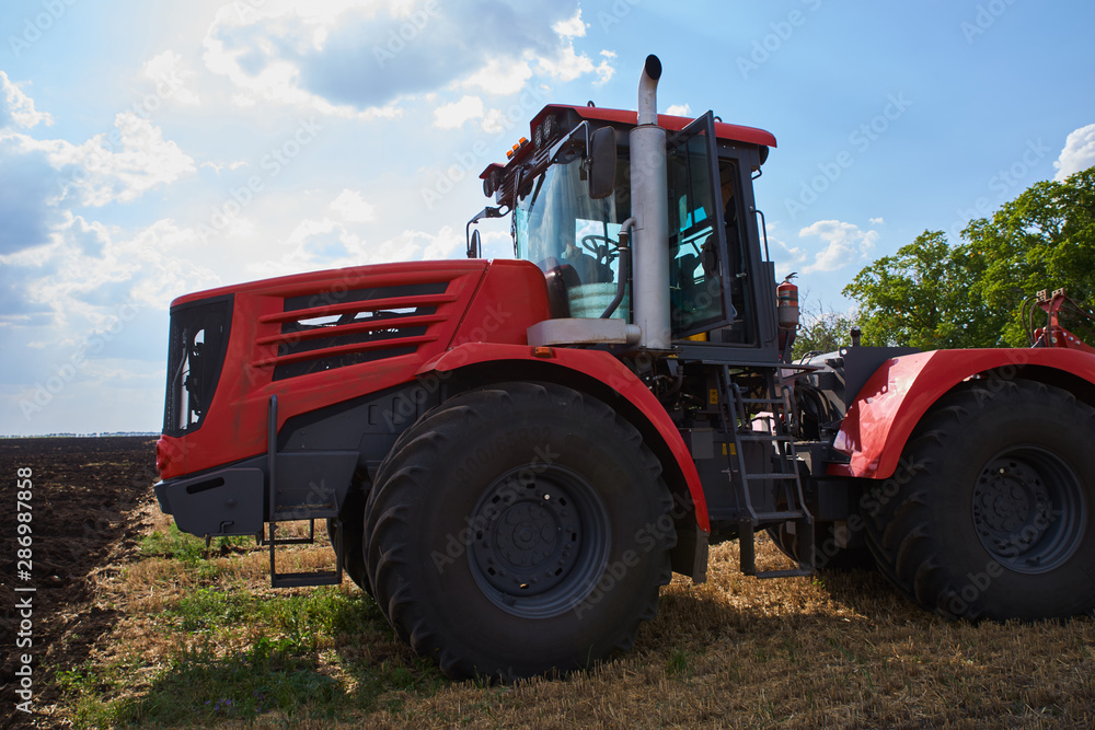 Tractor plows field, cultivators soil for sowing Tractor plows field, cultivators soil for sowing