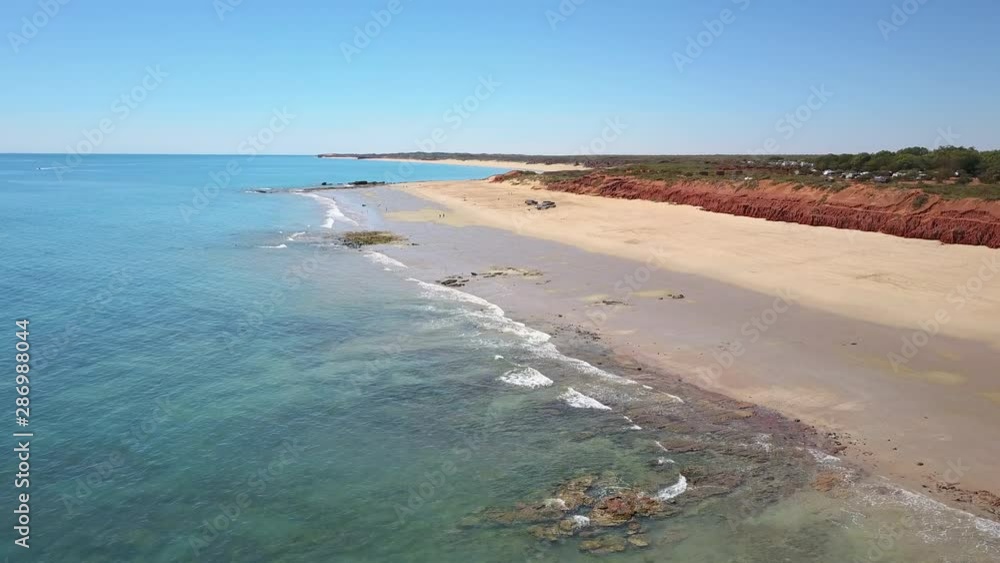 Aerial panoramic view of remote scenic beach and coast near Broome in Western Australia, with people camping and fishing, turquoise ocean water, sunny blue sky and horizon as background and copy space Aerial panoramic view of remote scenic beach and coast near Broome in Western Australia, with people camping and fishing, turquoise ocean water, sunny blue sky and horizon as background and copy space