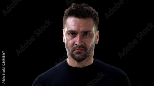 Dangerous male criminal looking camera, maniac thinking of murder, revenge
