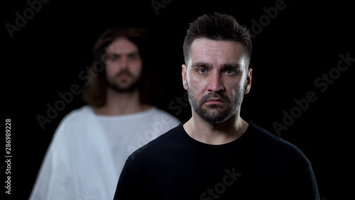 Depressed male and Jesus Christ background, soul salvation, spiritual protection