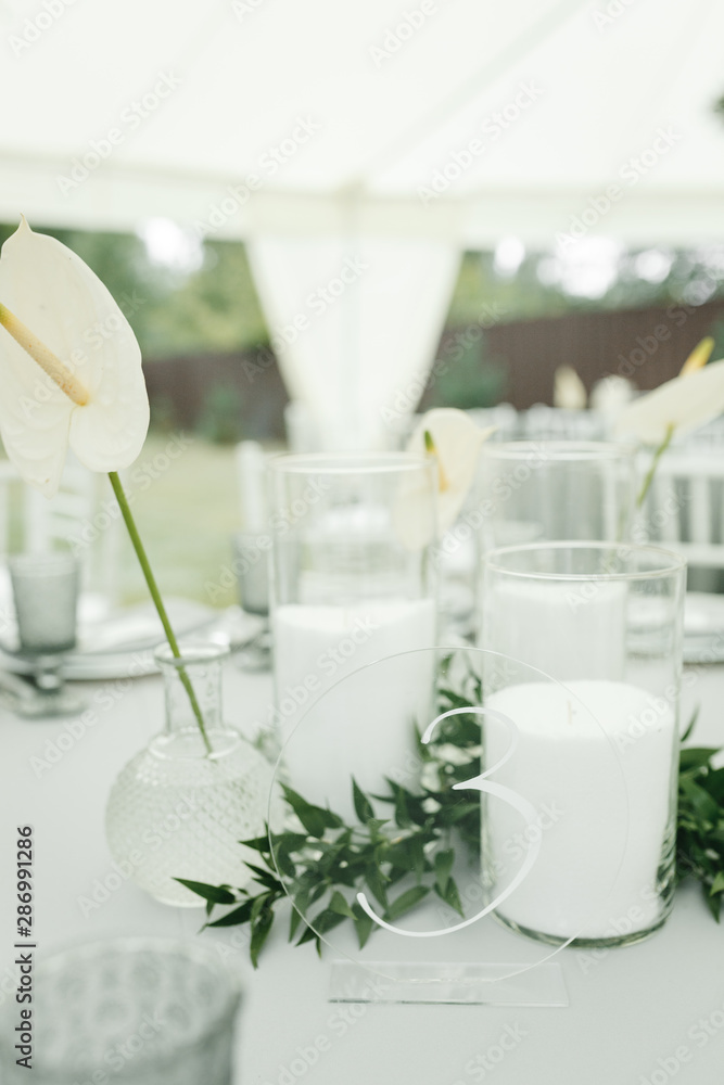 Aroma candles and the lily on the wedding table Aroma candles and the lily on the wedding table