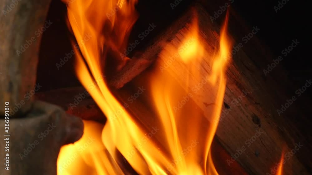 Pan up over wood burning in a ciminea Pan up over wood burning in a ciminea