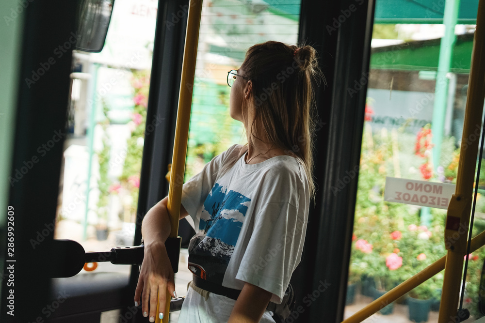 Athens, Greece - October 2018. Young woman riding in public transport Athens, Greece - October 2018. Young woman riding in public transport