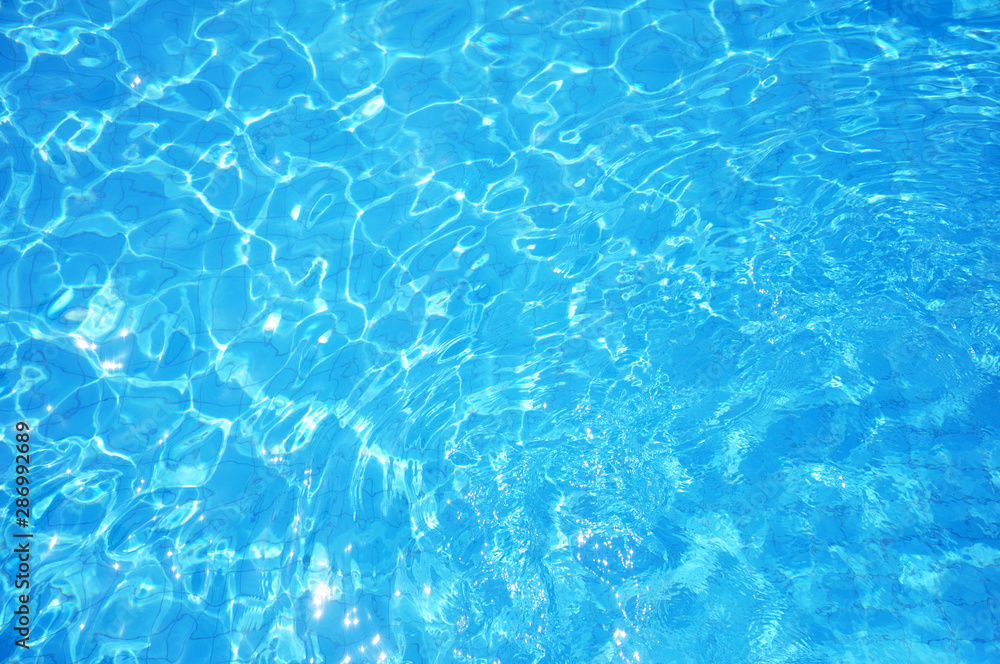 Swimming pool bottom caustics ripple and flow with waves background. Summer background. Texture of water surface. Swimming pool bottom caustics ripple and flow with waves background. Summer background. Texture of water surface.