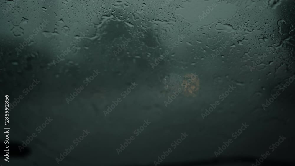 Car wipers cannot remove heavy rain from a car windshield during storm, difficult driving conditions. Car wipers cannot remove heavy rain from a car windshield during storm, difficult driving conditions.
