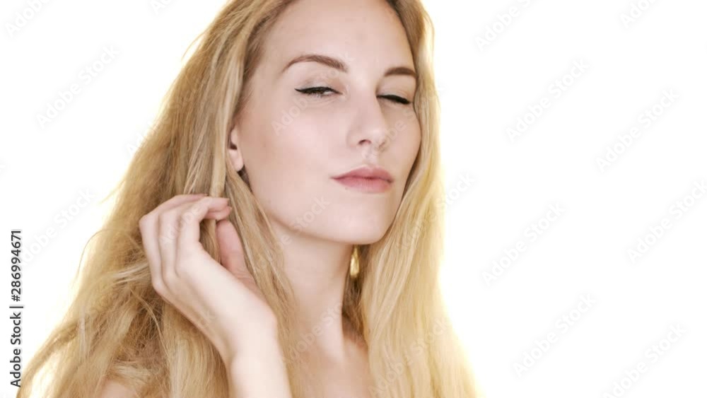 A beautiful young blonde woman comes into focus, before posing confidently and suggestively A beautiful young blonde woman comes into focus, before posing confidently and suggestively