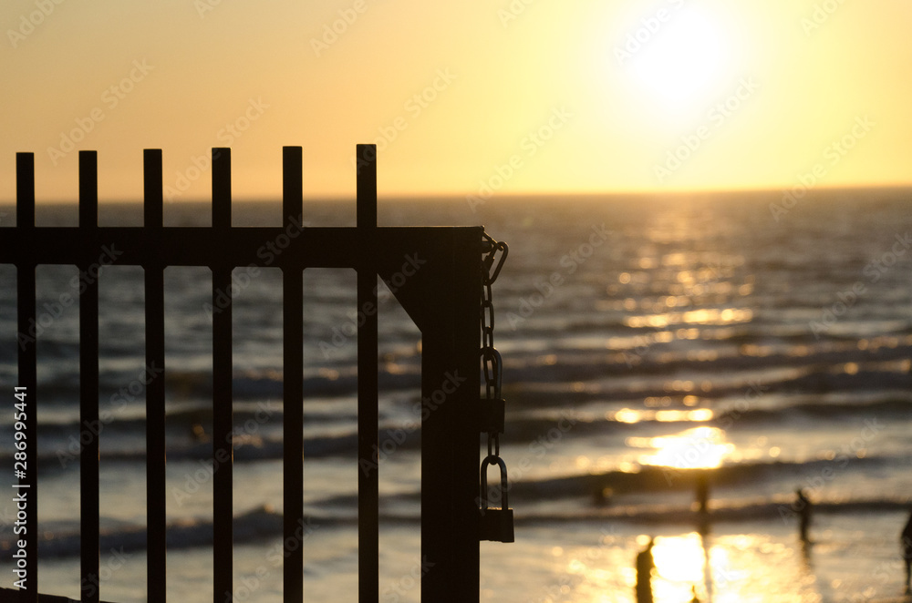 Lock on a grid at Newport Beach pier highlighted by sunset