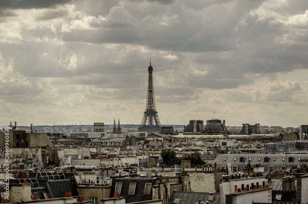 Cloudy view over the rooftops of the France city Paris.