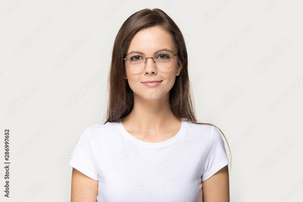 Headshot portrait of millennial girl in glasses posing in studio Headshot portrait of millennial girl in glasses posing in studio