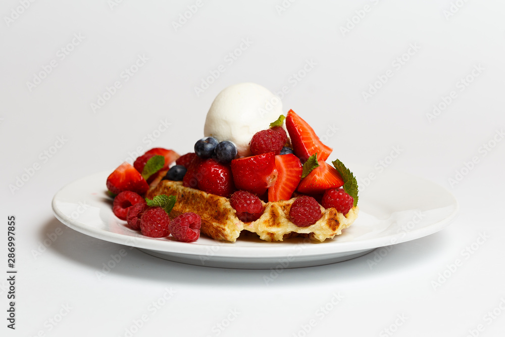 Belgian waffle with ice cream and a berries Belgian waffle with ice cream and a berries