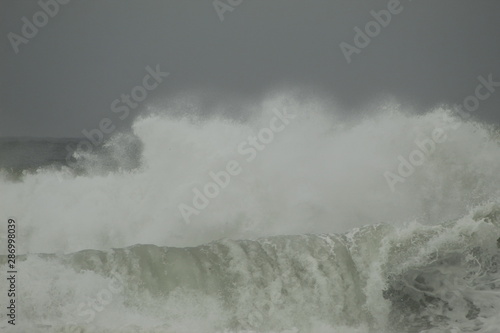 Surfing the waves on the beach of Matosinhos in Porto  Portugal. August 2019