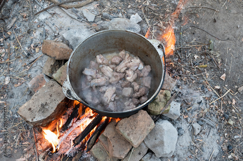Cooking meat at the stake. Cooking meat in a cauldron.