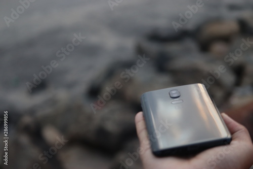 A smart phone holding in a hand