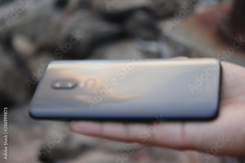 A smart phone holding in a hand