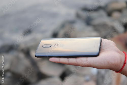 A smart phone holding in a hand