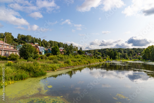 Fototapeta Naklejka Na Ścianę i Meble -  The Shokhonka River in Plyos and many small houses in the town