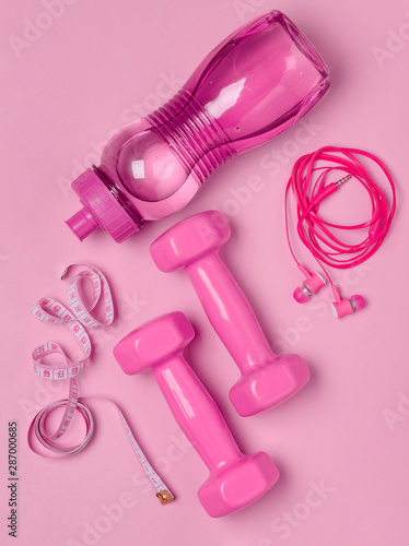 Pink fitness accesories on background