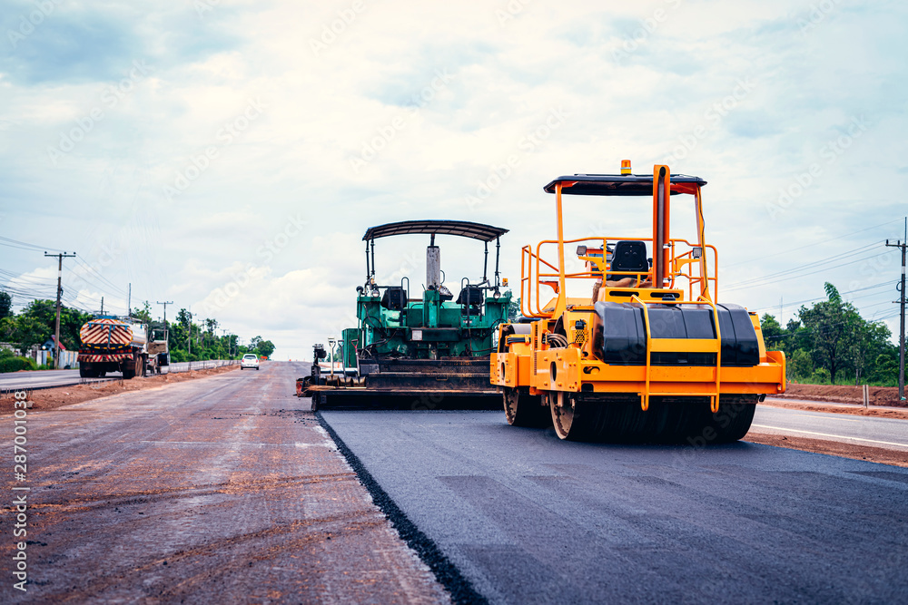 Road works in the city. Working on special equipment cut off the old asphalt on a Sunny summer day Road works in the city. Working on special equipment cut off the old asphalt on a Sunny summer day