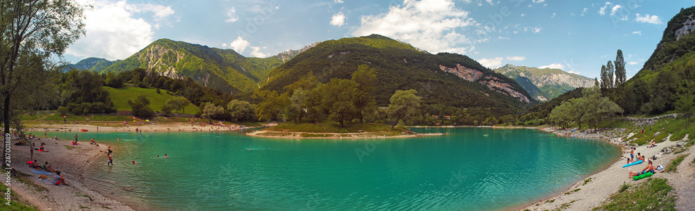 Lago di Tenno (Italy, Alps) - lake in mountains with island and beach, mountains in background, Summer sunny day