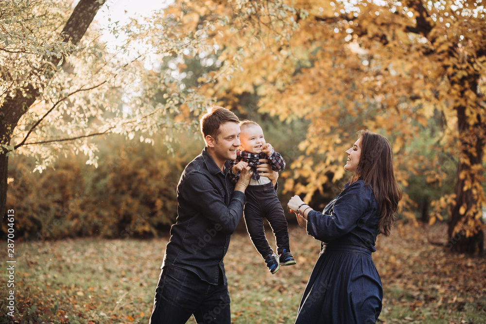 Family with a child in a beautiful autumn park Family with a child in a beautiful autumn park