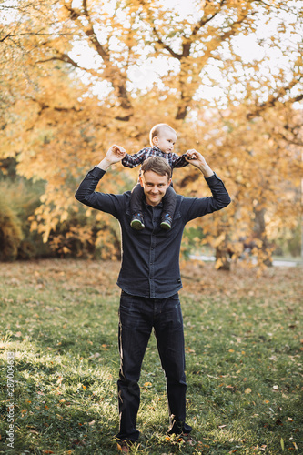 Father with a child in a beautiful autumn park