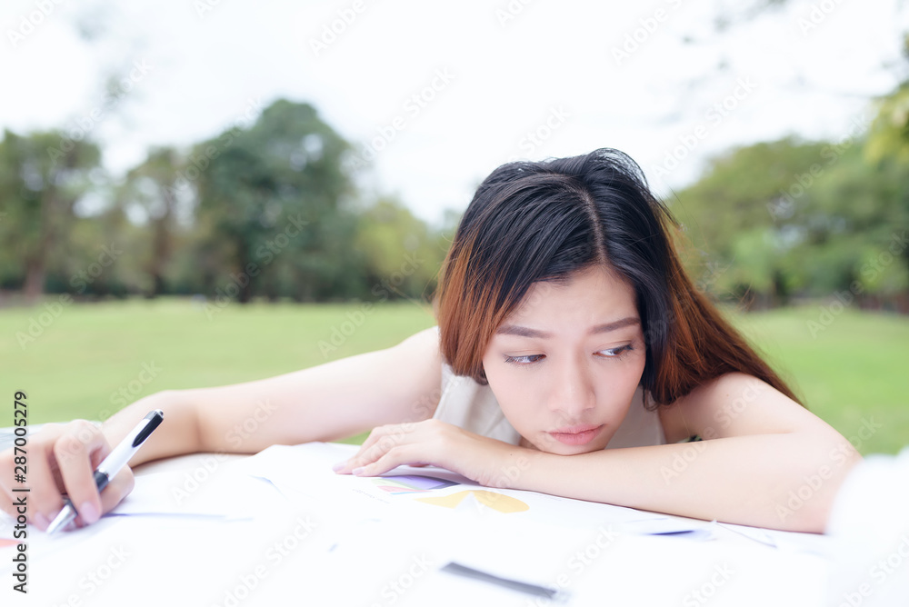 Beautiful business woman thinking about something while working in the park. Beautiful business woman thinking about something while working in the park.