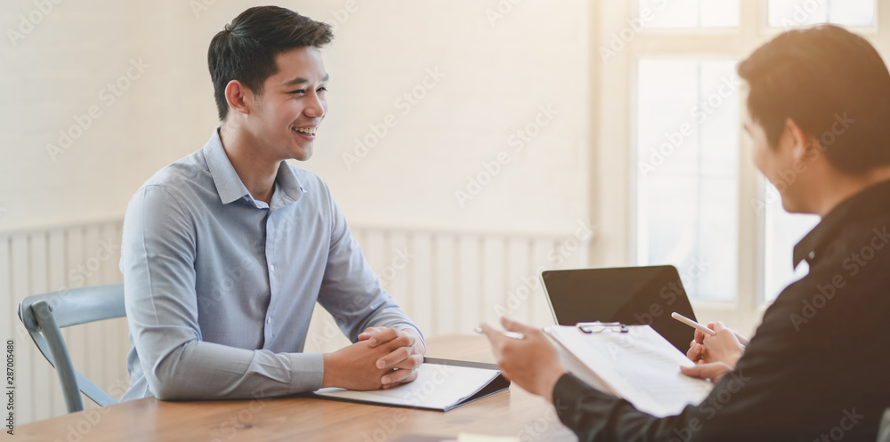 Professional businessman discussing the project with his coworker Professional businessman discussing the project with his coworker
