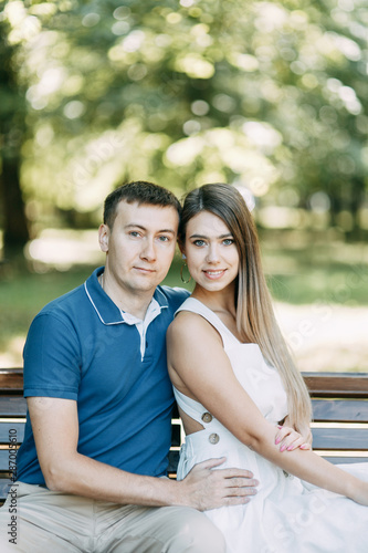  Happy people enjoy the good weather. Beautiful couple walking in the Park in the summer. © pavelvozmischev