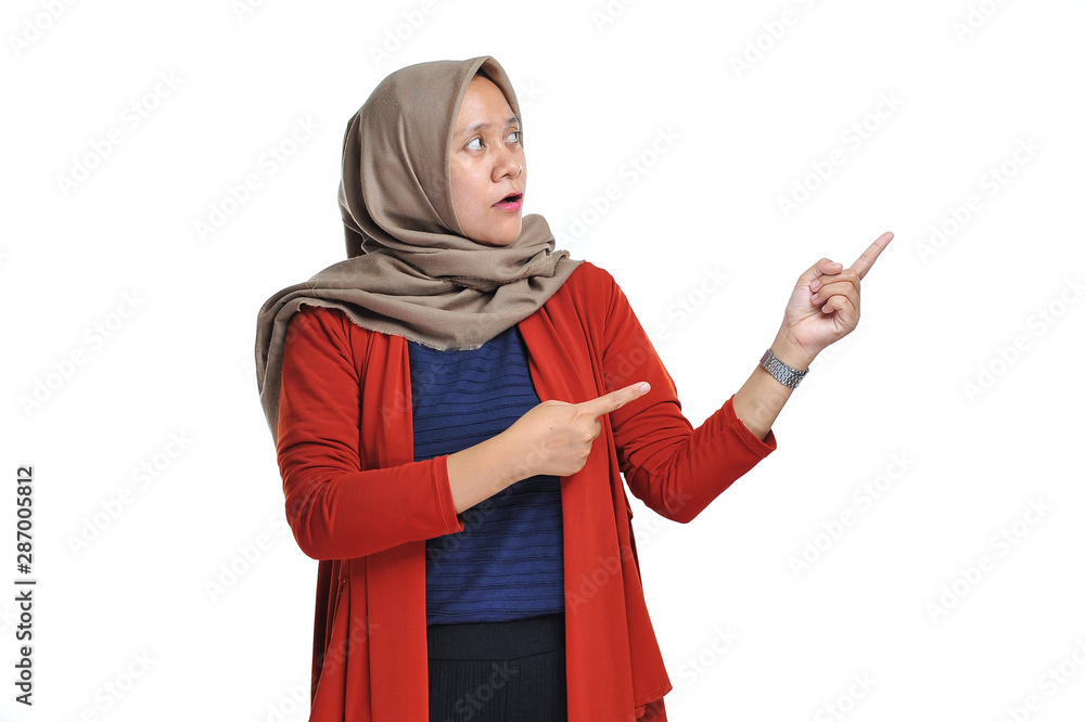 Impressed expression of beautifull asian woman pointing of a copyspace Impressed expression of beautifull asian woman pointing of a copyspace
