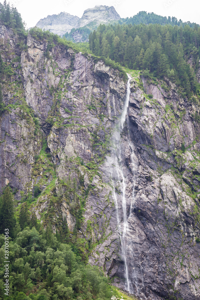 Small but high waterfall from a mountain in the Alps Small but high waterfall from a mountain in the Alps