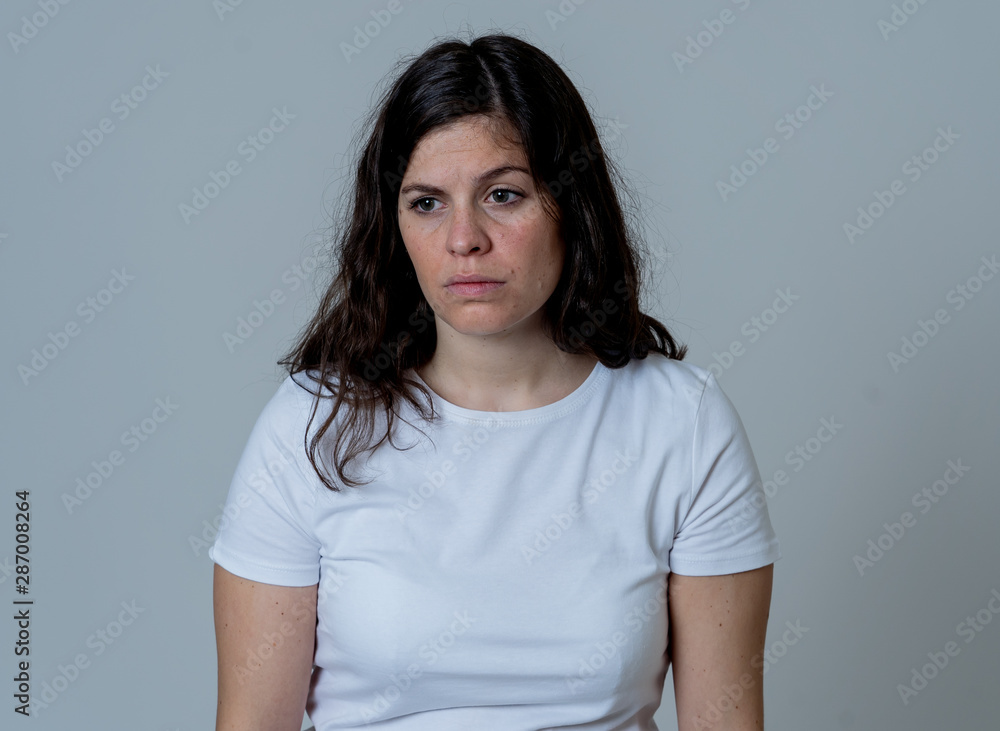 Portrait of sad and depressed woman. Isolated on neutral background. Human expressions and emotions Portrait of sad and depressed woman. Isolated on neutral background. Human expressions and emotions
