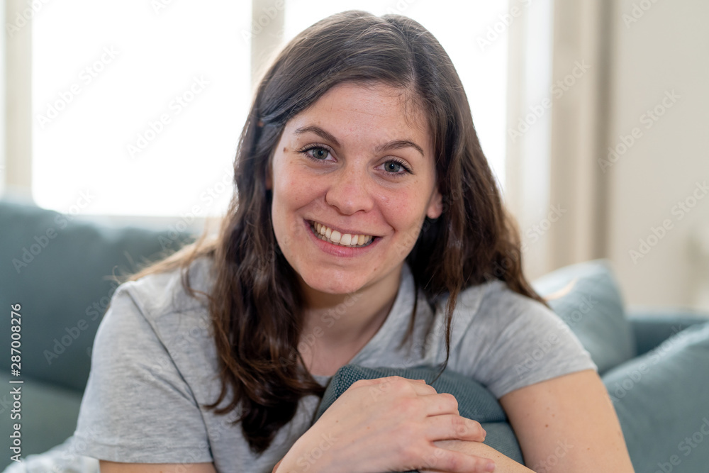 Beautiful lifestyle portrait of young woman happy and relaxed at home